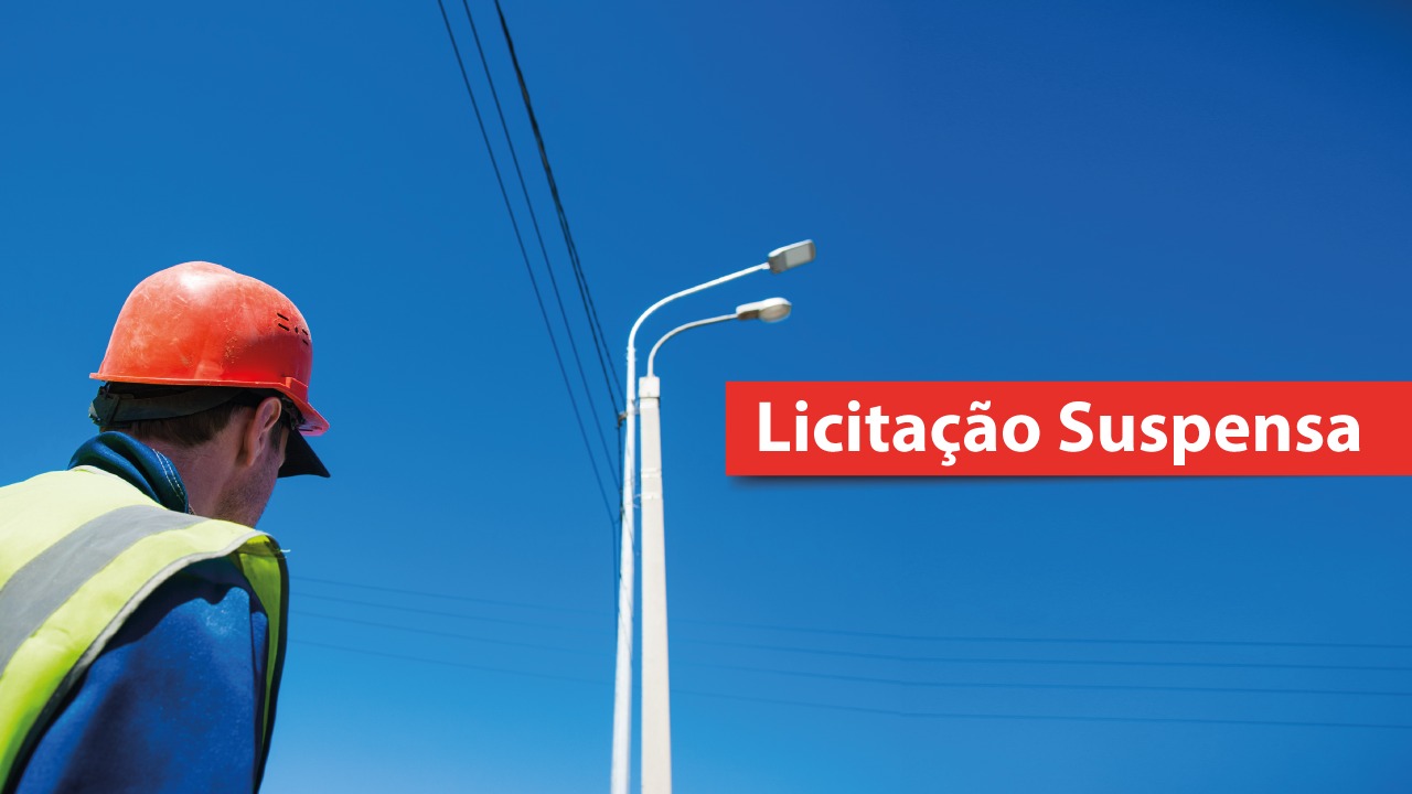 Imagem apresenta um poste com luminárias e fios elétricos sob céu azul, com texto em destaque: “Licitação Suspensa” 