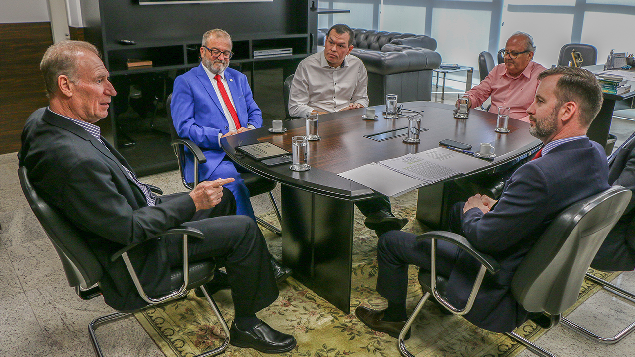 Foto de seis homens sentados ao redor de uma mesa, durante a reunião entre o TCE/SC e o TJSC, enquanto conversam. Entre eles, os conselheiros Herneus De Nadal, Adircélio de Moraes Ferreira Júnior e Wilson Wan-Dall, e o presidente do TJSC, Altamiro de Oliveira. 