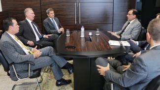 Foto do gabinete da presidência do TJ/SC, em que aparecem sentados, ao redor de uma mesa, o presidente do TJSC, desembargador Francisco Oliveira Neto, e os conselheiros Herneus De Nadal, José Nei Ascari e Adircélio de Moraes Ferreira Júnior, e outros integrantes do TJ. Eles estão de terno e conversam entre si.