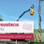 Imagem mostra uma equipe de manutenção mexendo em um poste de energia elétrica em uma área rural. À esquerda, há um título onde se lê "Jurisprudência" e "Taxa de iluminação pública rural"